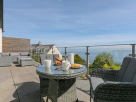 An outdoor seating area with a table and chairs at 2 Remera in St Ives