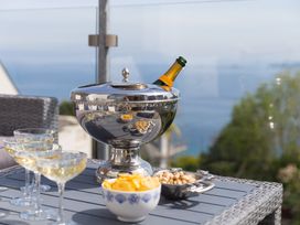 A champagne cooler with glasses and snacks on a table at 2 Remera in St Ives
