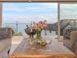 A living room with champagne glasses and a vase of flowers at 2 Remera St Ives