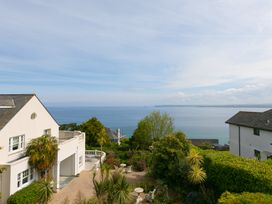 A view of a house and garden overlooking the ocean at 2 Remera St Ives