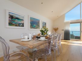 A dining room with a table set for meals at 2 Remera St Ives