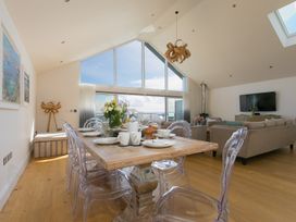 A dining area with a table and chairs at 2 Remera St Ives