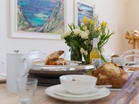 A dining room table set with food and drinks at 2 Remera St Ives