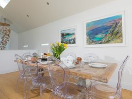 A dining room with a table set for meals at 2 Remera St Ives