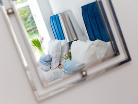 A bedroom with a bed and a lamp at 2 Remera, St Ives