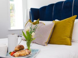 A bedroom with a bed and breakfast tray at 2 Remera St Ives
