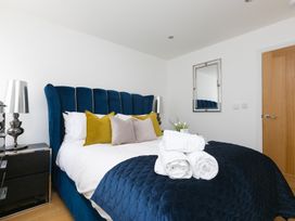 A bedroom with a bed and nightstand at 2 Remera in St Ives