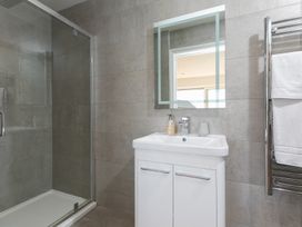 A bathroom with a shower and washbasin at 2 Remera St Ives