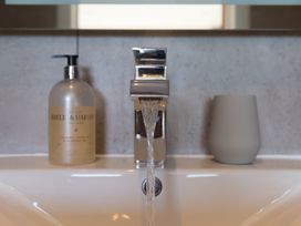 A sink with a faucet and soap dispenser at 2 Remera St Ives
