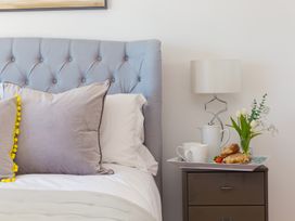 A bedroom with a bed, lamp, and breakfast tray at 2 Remera St Ives