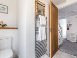 A bathroom with a toilet and towel rail at Orchard View in St. Austell