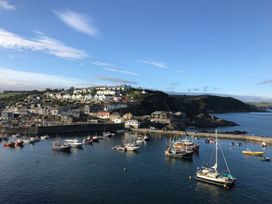 A harbor with boats and houses on a hill at Orchard View in St. Austell