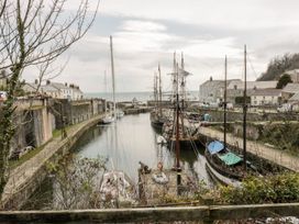 A harbor with boats and buildings at Orchard View in St. Austell