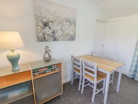 A dining room with a table and chairs at Falconers Cottage