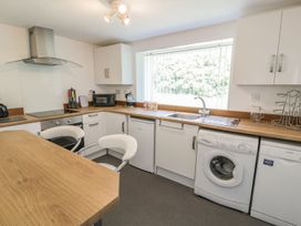 A kitchen with appliances and workspace at Falconers Cottage 