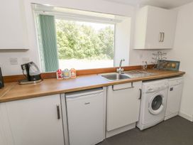 A kitchen with a sink and appliances at Falconers Cottage 