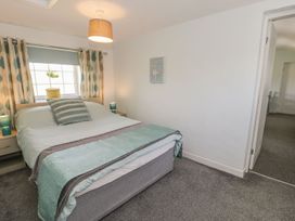 A bedroom with a bed and window at Falconers Cottage in 