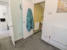 A bathroom with a towel hanging and a sink at Falconers Cottage