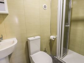 A bathroom with a toilet and shower at Falconers Cottage