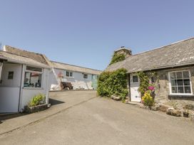 An outdoor area with cottages and benches at Falconers Cottage
