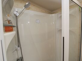 A shower with soap dispenser at Beachside in Towyn