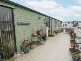 An outdoor area with a mobile home and planters at Beachside in Towyn