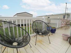 An outdoor area with chairs and planters at Beachside in Towyn