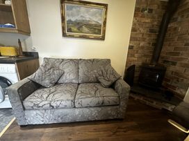 A living room with a sofa and a fireplace at The Rocks in Newry