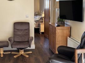 A living room with an armchair and television at The Rocks in Newry