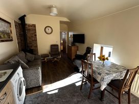 A living room with a sofa and dining table at The Rocks in Newry
