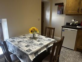 A kitchen with a table and chairs at The Rocks in Newry