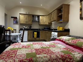 A kitchen with a bed and dining area at The Rocks in Newry