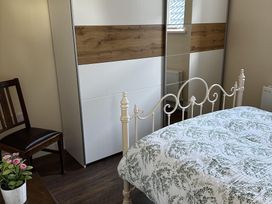 A bedroom with a bed and a wardrobe at The Rocks in Newry