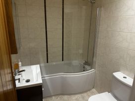 A bathroom with a bathtub, shower, toilet, and sink at The Rocks in Newry