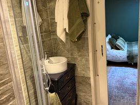 A bathroom with a sink and shower at Studio Apartment at High Dyke Farm Cockermouth