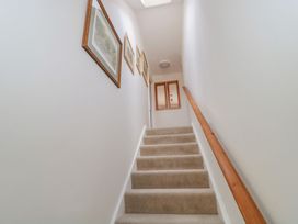 A staircase with pictures on the wall at Greenham Rise in Norton-Sub-Hamdon