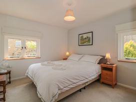 A bedroom with a bed and nightstands at Greenham Rise in Norton-Sub-Hamdon
