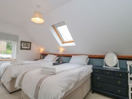 A bedroom with two beds and a window at Greenham Rise in Norton-Sub-Hamdon
