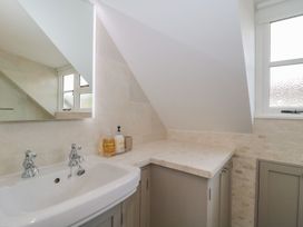 A bathroom with a sink and cabinet at Greenham Rise in Norton-Sub-Hamdon