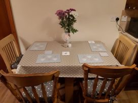 A dining room table with flowers and place mats at 87 Ballyveaghmore Road in Newry