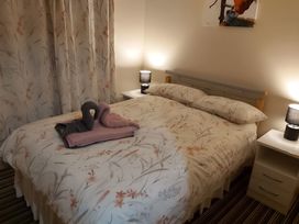 A bedroom with a bed and bedside tables at 87 Ballyveaghmore Road in Newry