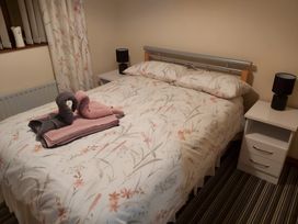A bedroom with a bed and towels on it at 87 Ballyveaghmore Road in Newry