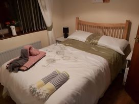 A bedroom with a bed and towels at 87 Ballyveaghmore Road in Newry