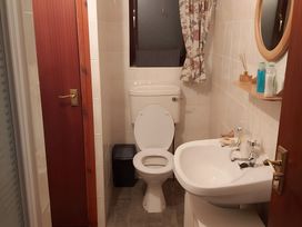 A bathroom with a toilet and sink at 87 Ballyveaghmore Road in Newry