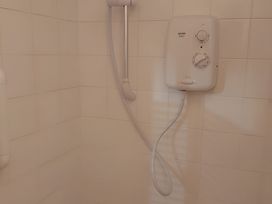 A shower with a control panel and tiles at 87 Ballyveaghmore Road in Newry