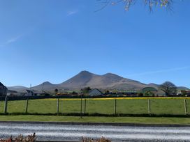 A mountain and field view with houses at 87 Ballyveaghmore Road in Newry