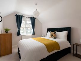 A bedroom with a bed and a window at The Cottage in Helston