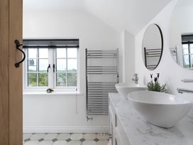 A bathroom with sinks and a window at The Cottage in Helston