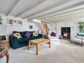 A living room with a sofa and coffee table at The Cottage in Helston
