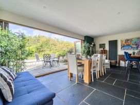 A dining room with a table and chairs at The Cottage in Helston